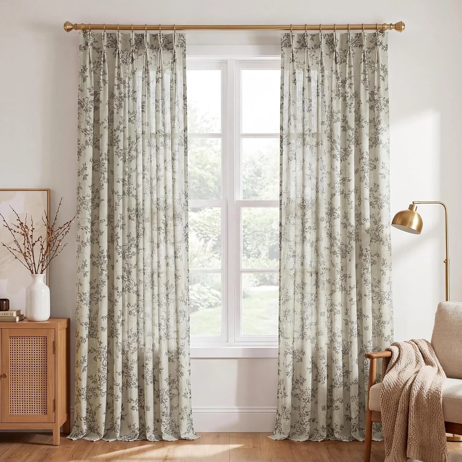 Beige floral linen-look curtains on a brass rod in a bright modern living room