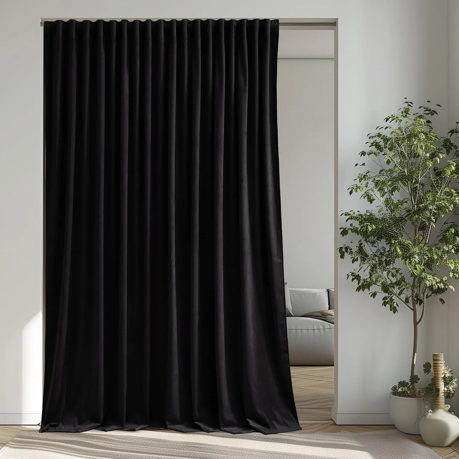 Black blackout curtain panel hanging in a minimalist modern room divider doorway