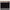Black curtain panel hanging from brown clip rings on a wood curtain rod