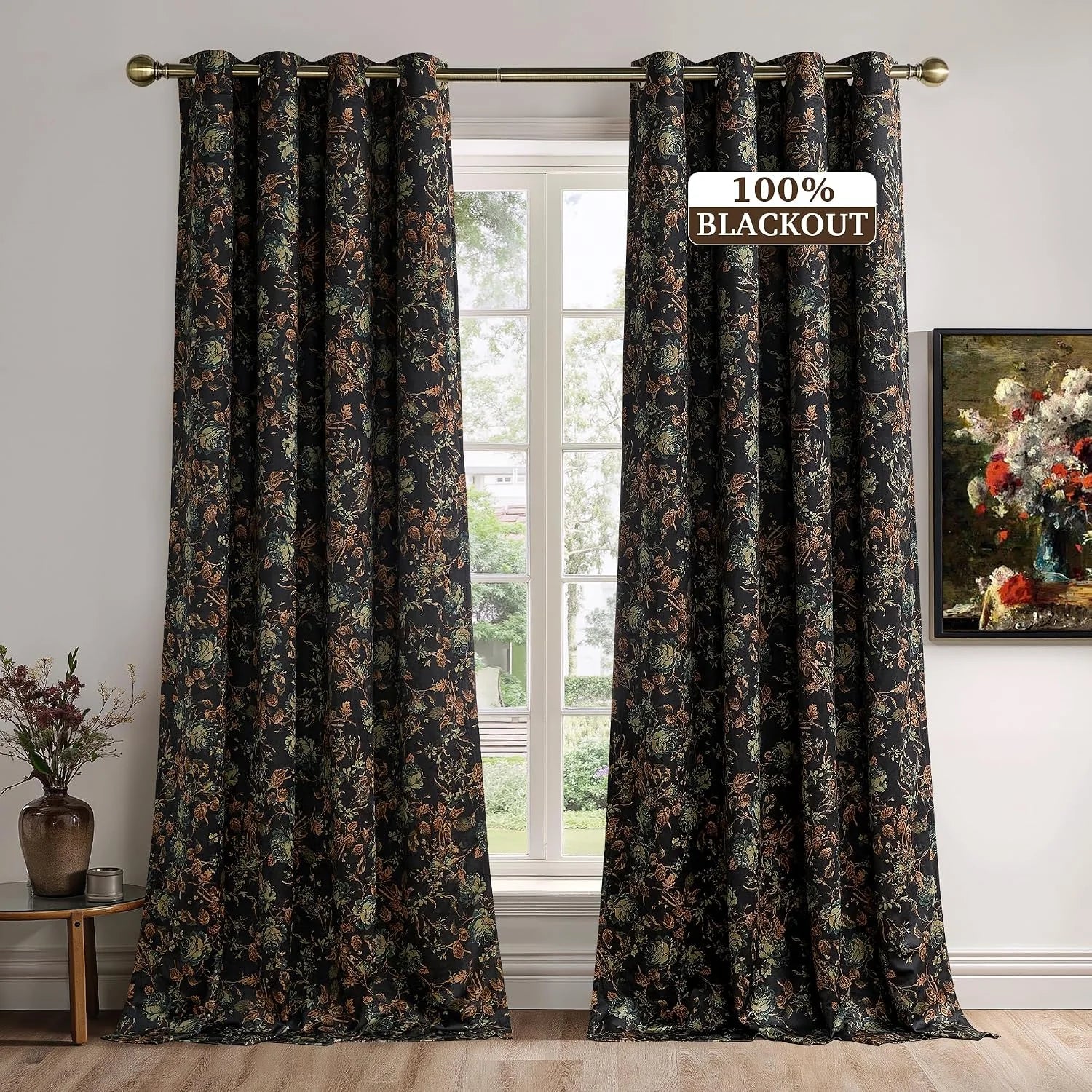 Black floral blackout curtains with vintage botanical print on brass rod by window