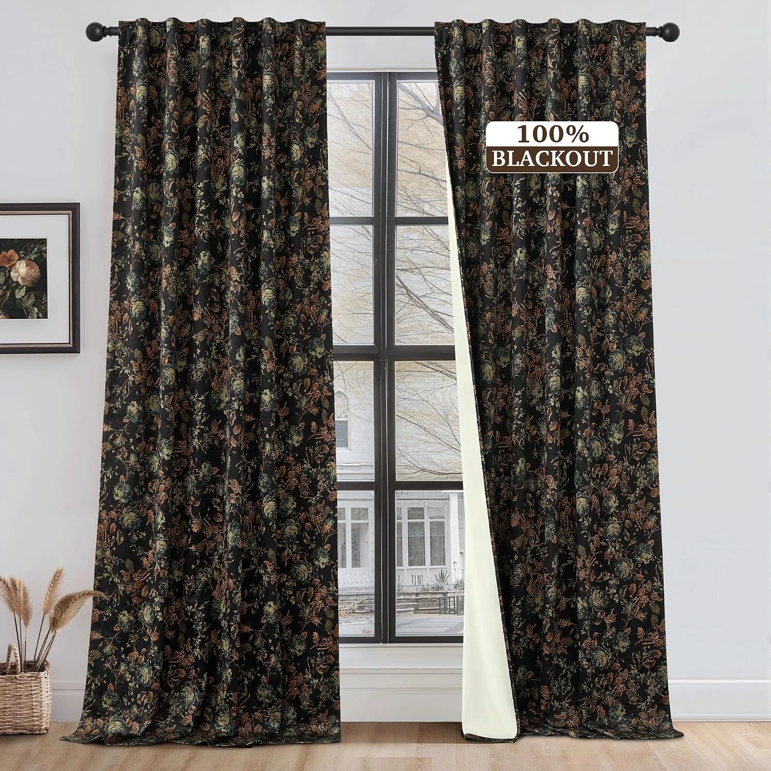Black floral blackout curtains with botanical print hanging on a window rod