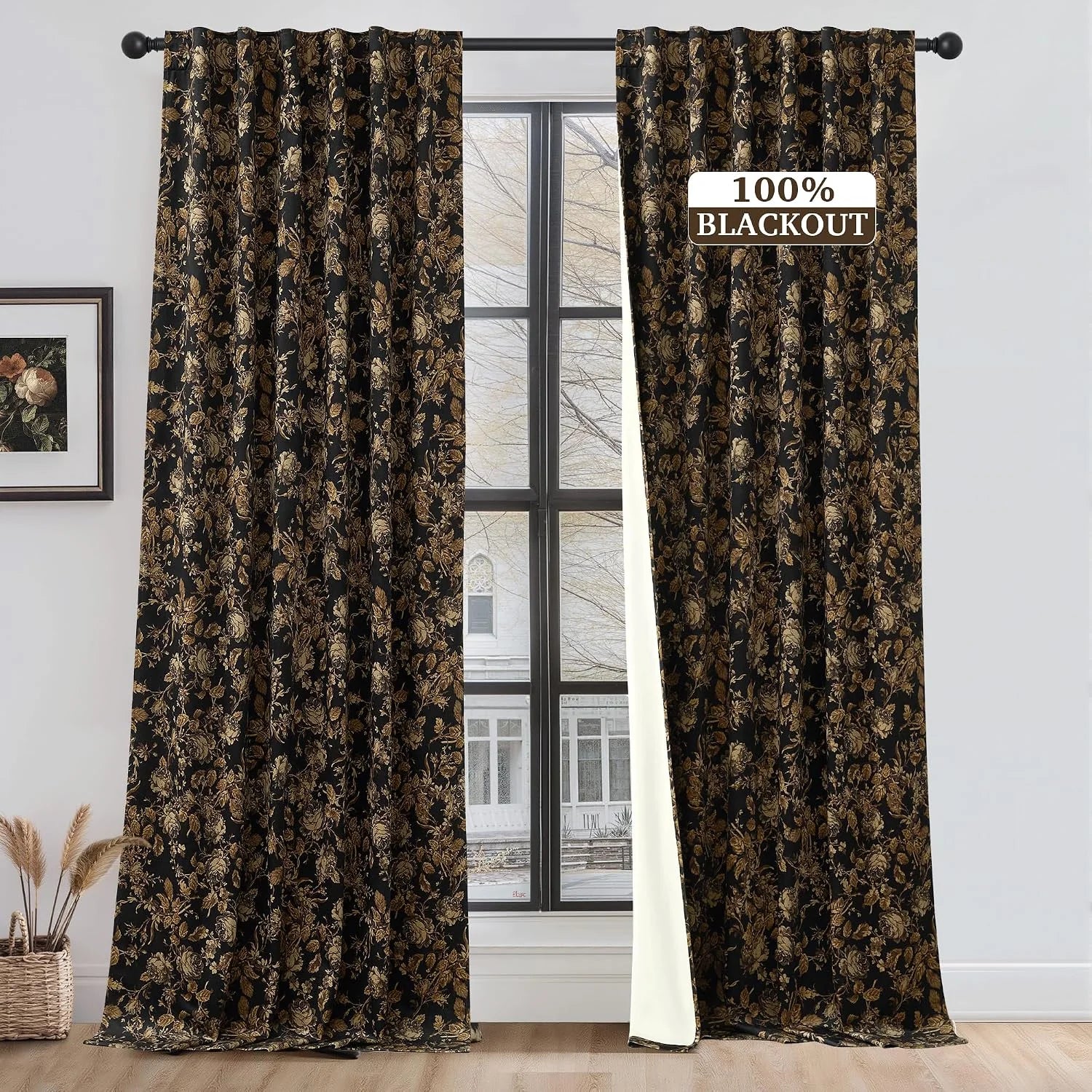 Black and gold floral blackout curtains on a rod in a bright modern room