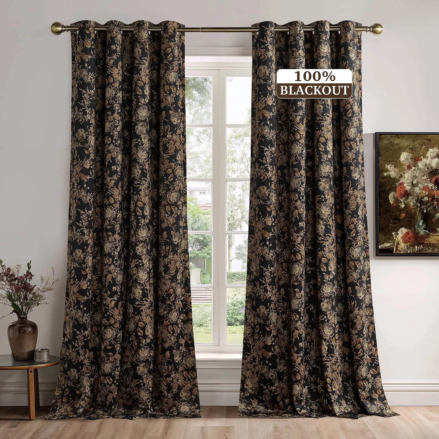 Black and gold floral blackout curtains on a brass rod in a bright living room window