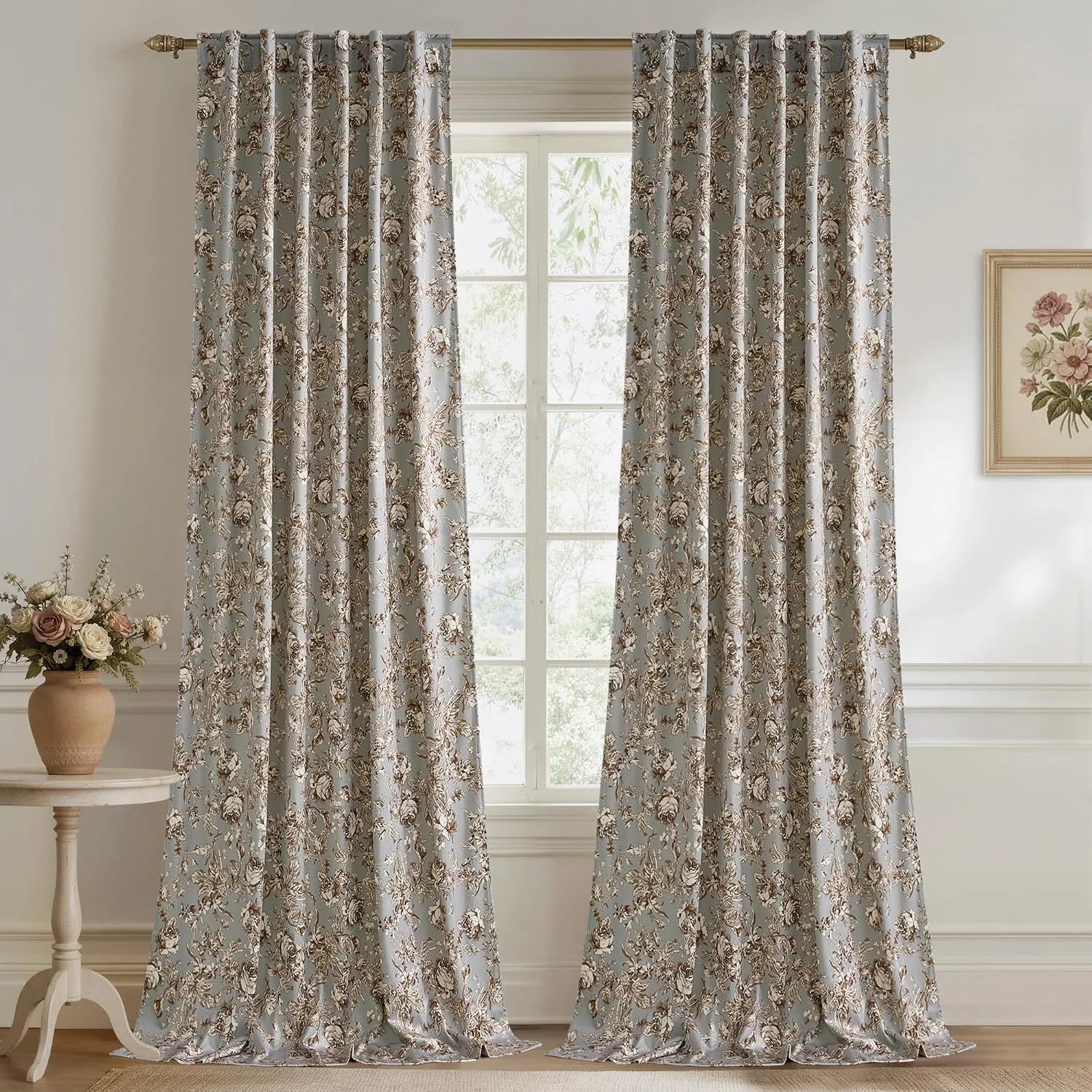 Pale blue floral curtains on a brass rod in a classic bright living room window
