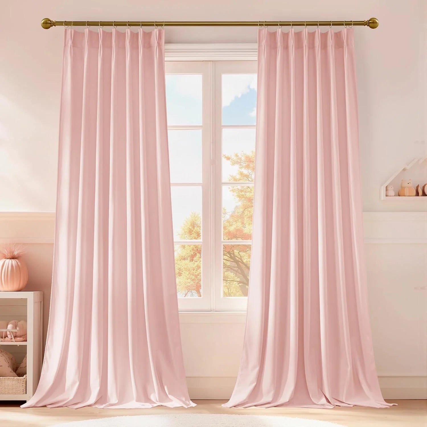 Blush pink pleated curtains on a gold rod in a soft, bright nursery-style room