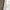 Brown floral light-filtering curtains with textured fabric and white backing by window