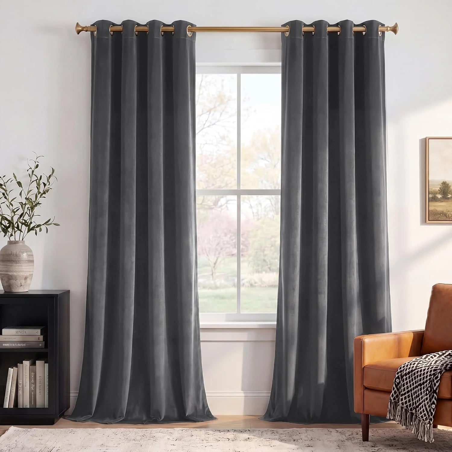 Charcoal gray velvet grommet curtains on a brass rod in a modern living room