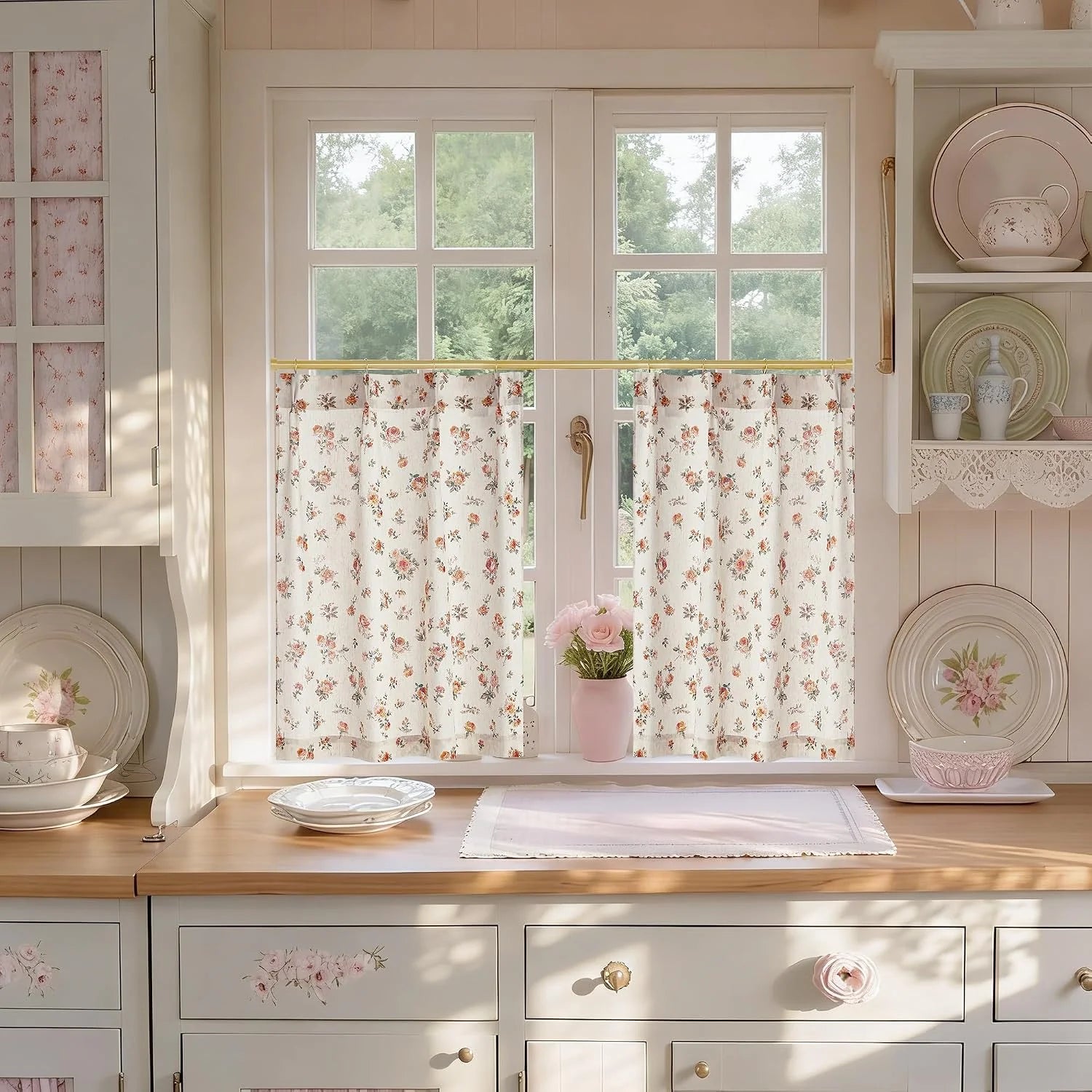 Cream floral cafe curtains on a brass rod over a bright farmhouse kitchen window