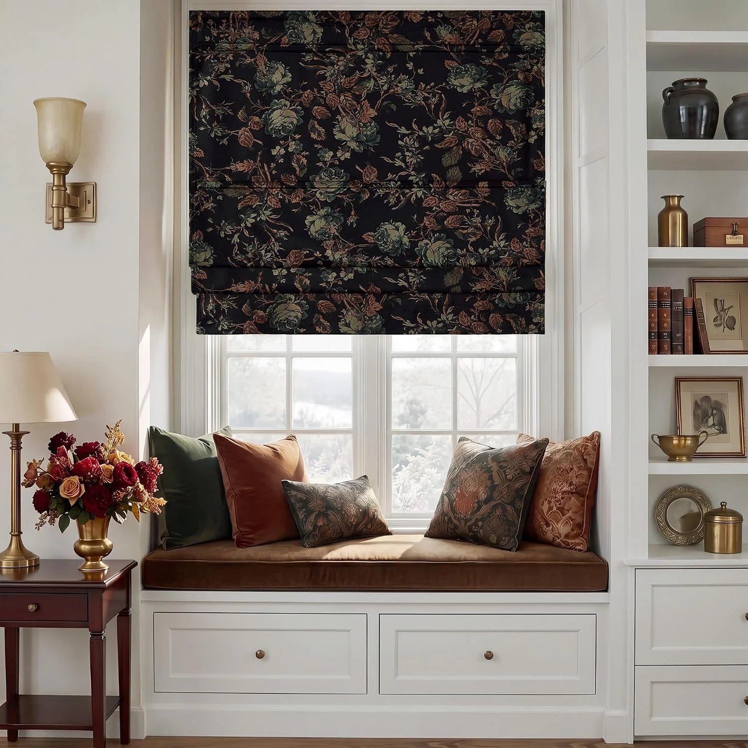 Dark floral Roman shade above a built-in window seat with warm-toned pillows