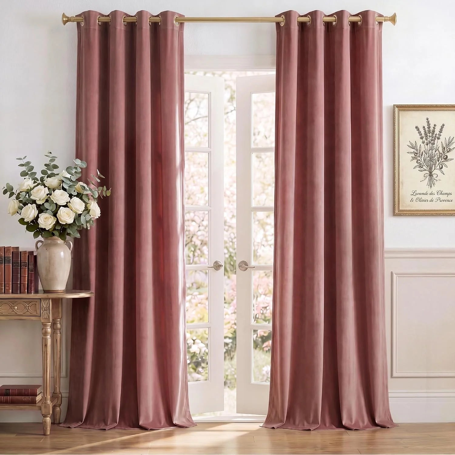 Dusty rose velvet grommet curtains hanging on a gold rod over French doors