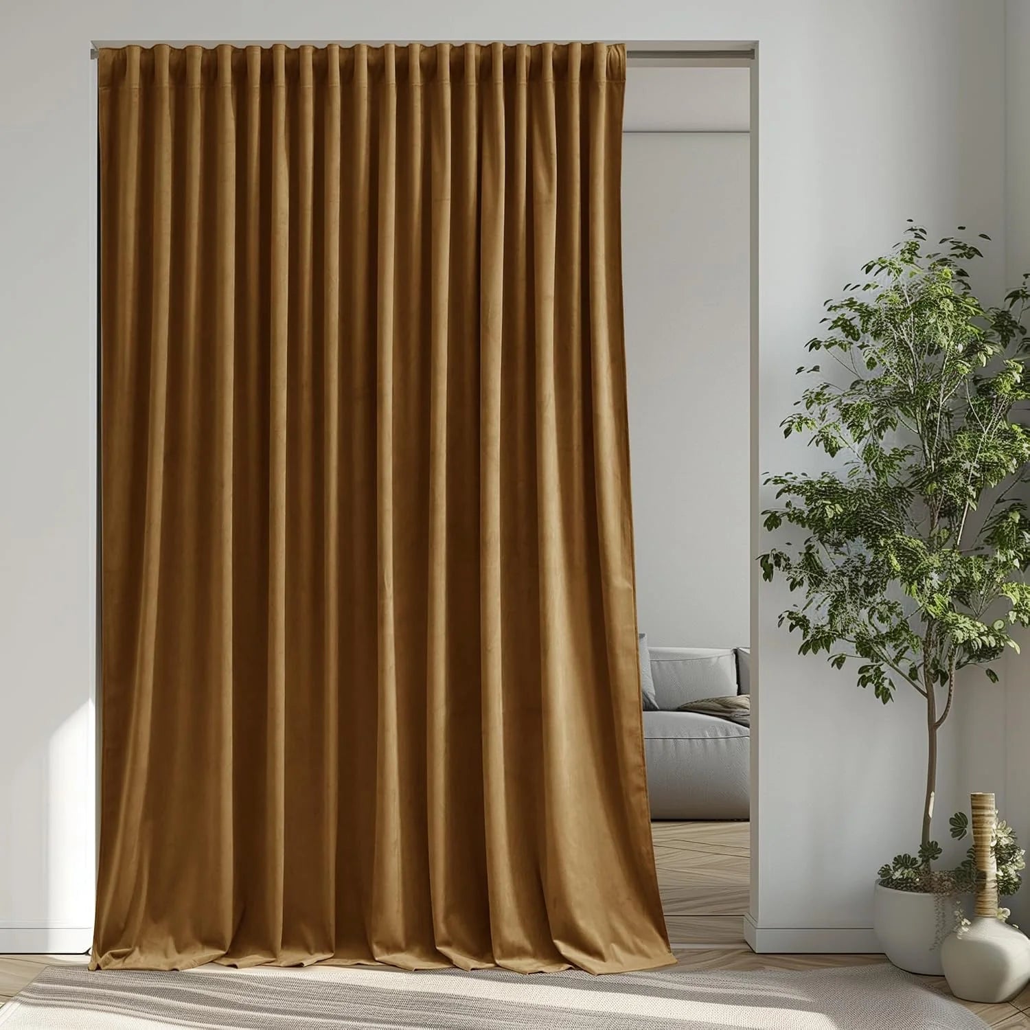 Gold velvet pleated curtain hanging in a bright modern room beside a potted tree