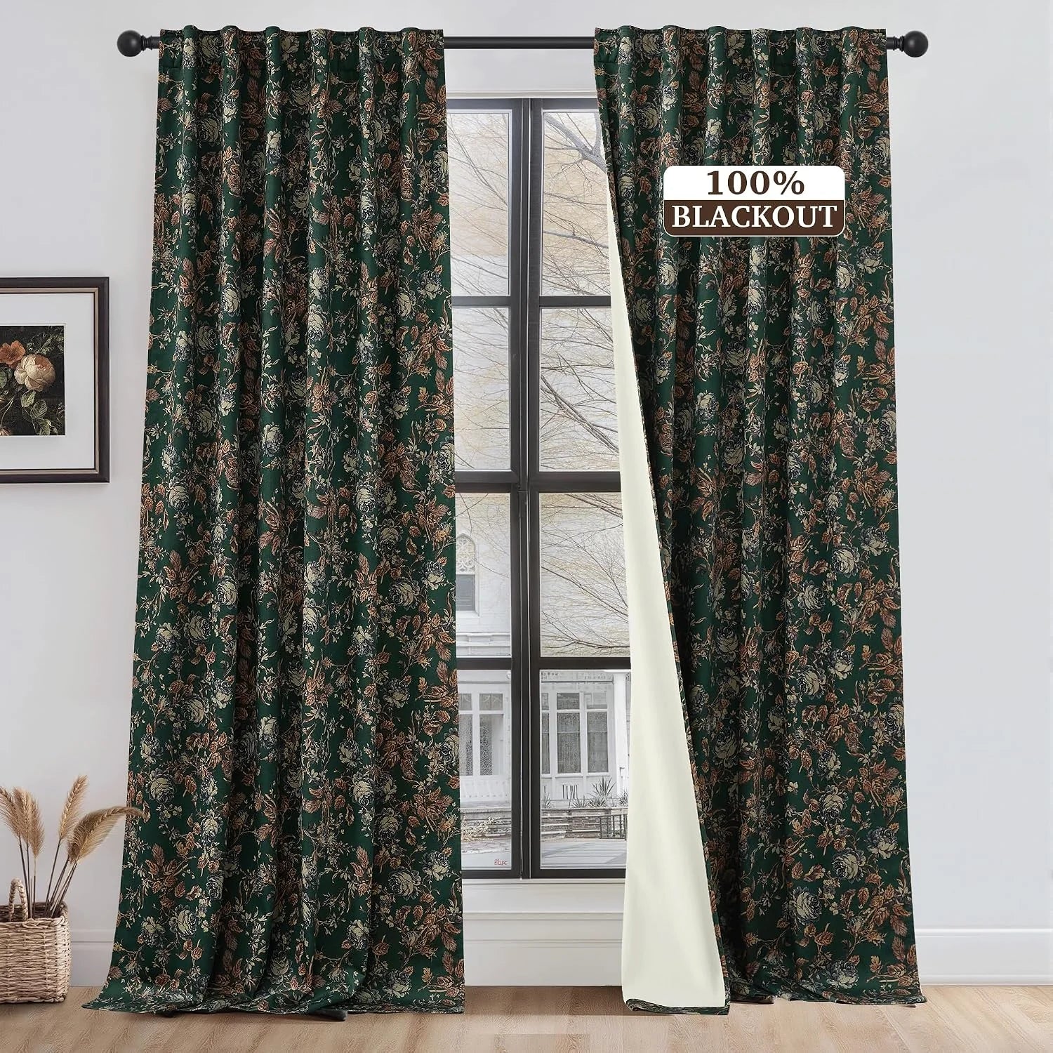Dark green floral blackout curtains on a black rod in a bright modern room
