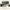 Green floral body pillow cover shown on bed across phone, laptop, and monitor screens