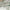 Soft white linen-look fabric with green floral print and draped folds