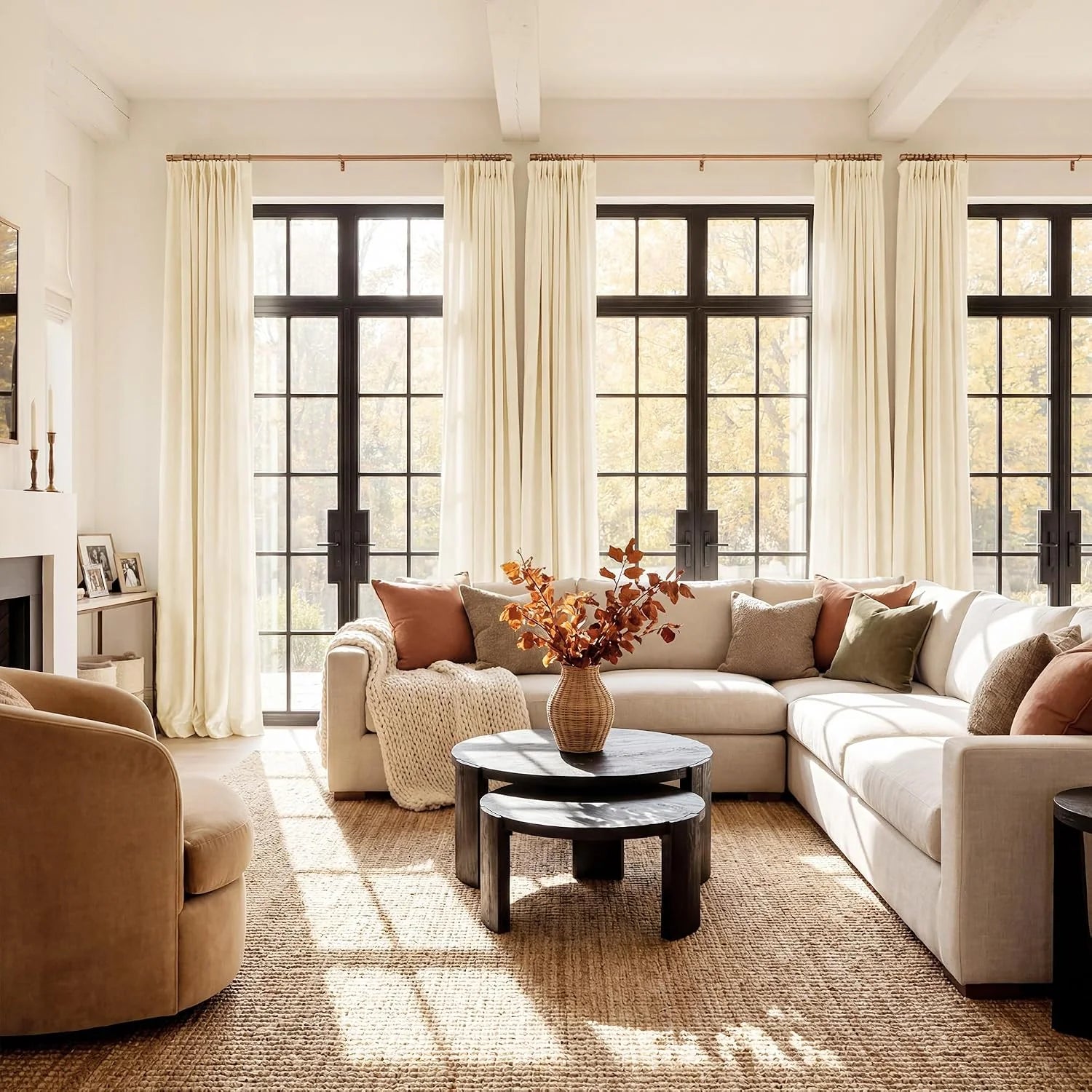 Ivory linen curtains framing black grid windows in a warm modern living room