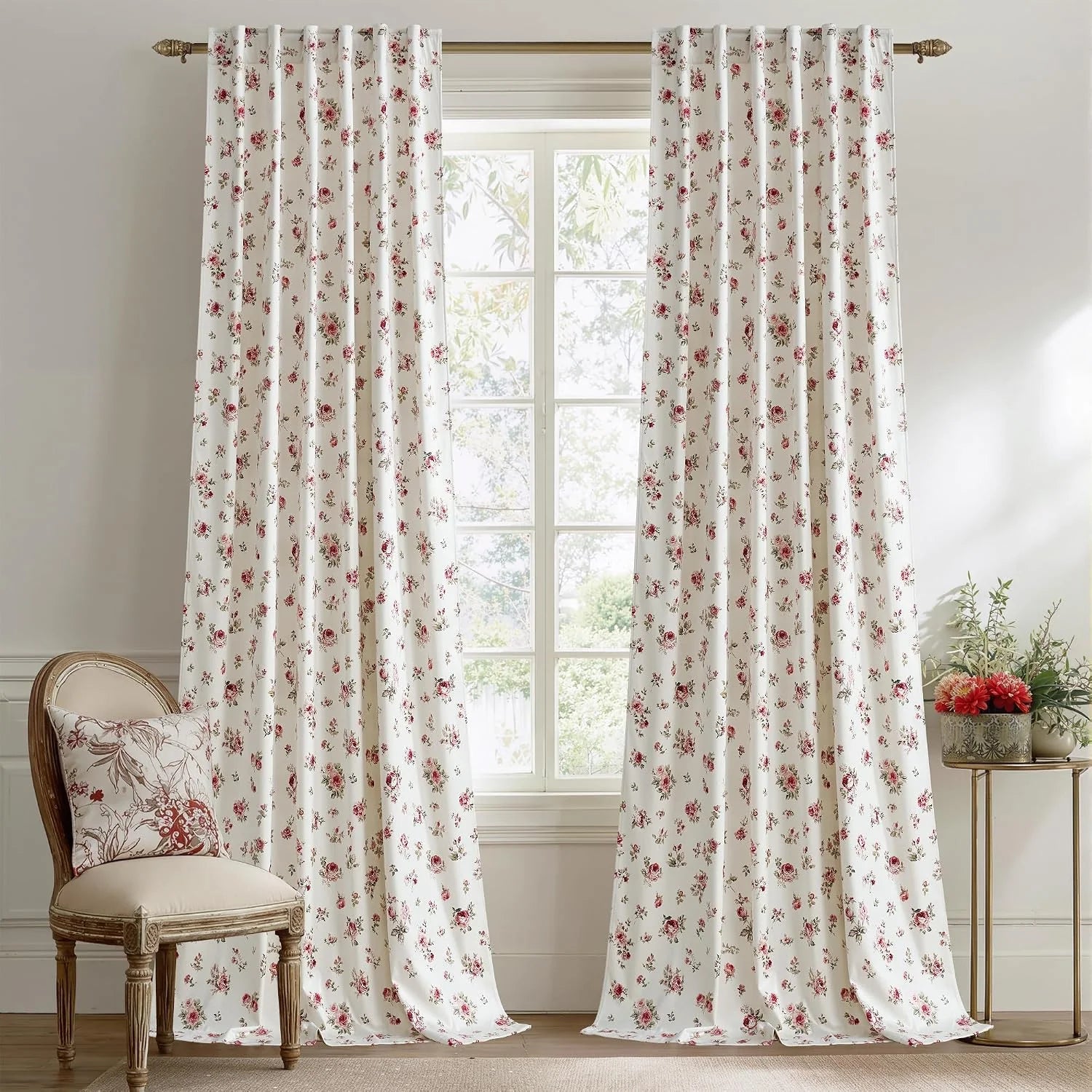 Ivory curtains with pink rose floral print hanging in a bright cottage-style room