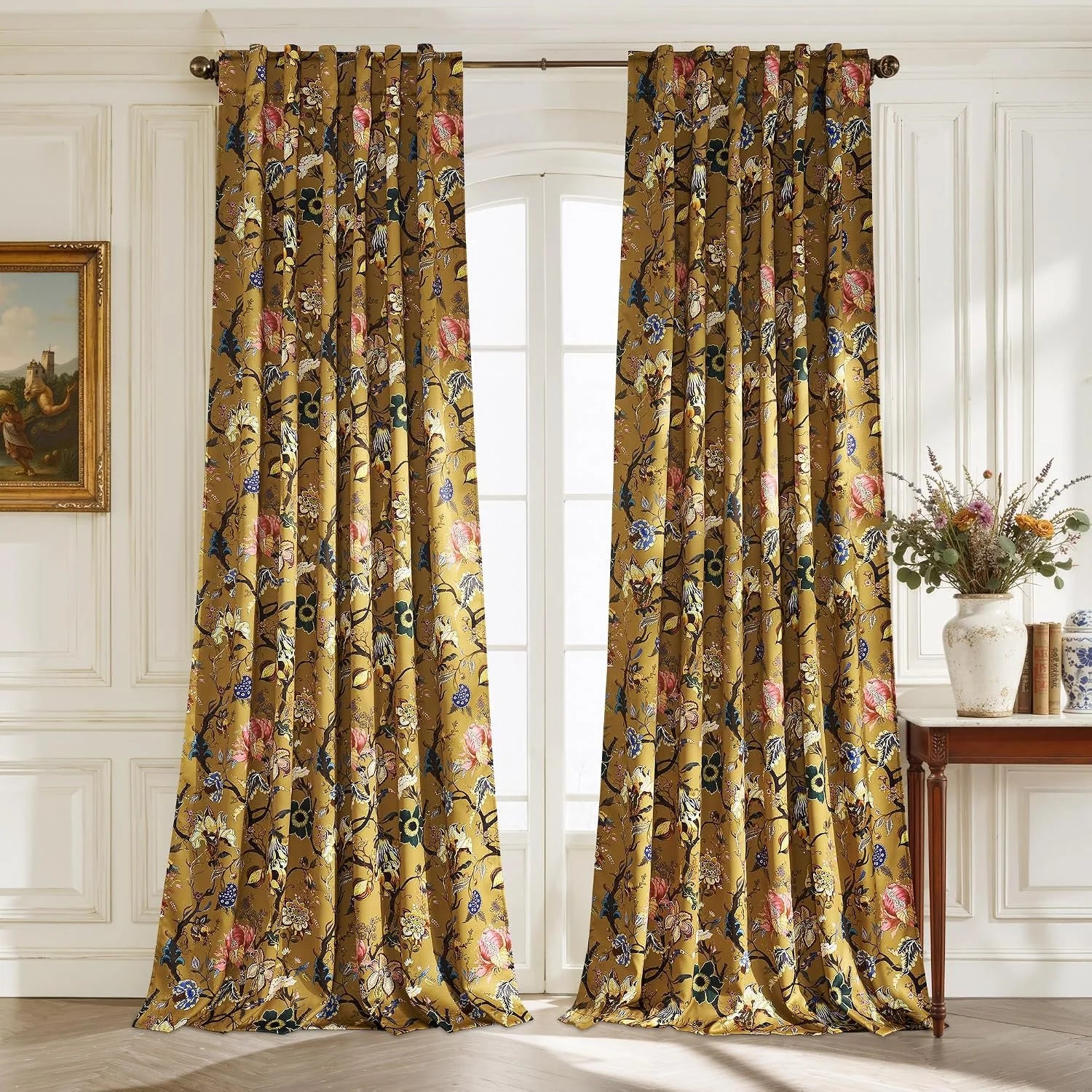 Mustard floral curtains with draped pleats hanging in a classic white paneled room