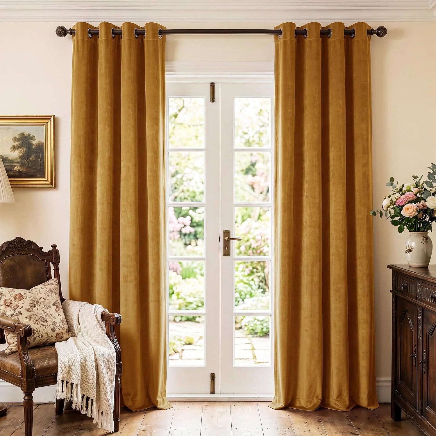 Mustard velvet grommet curtains hanging over white French doors in a classic room