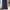 Navy velvet curtain draped beside a bright window in a warm modern living room