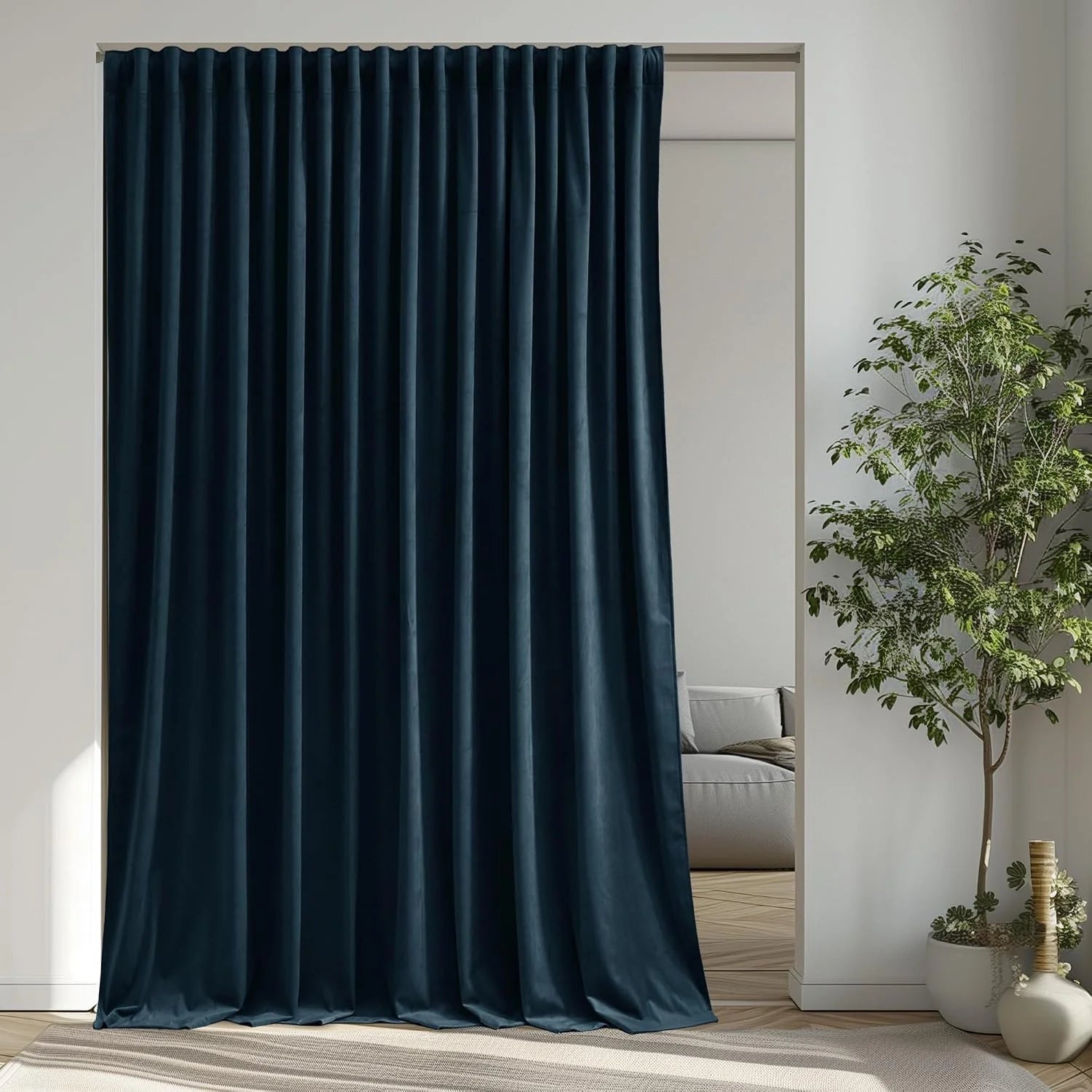 Navy velvet pleated room divider curtain in a bright modern interior