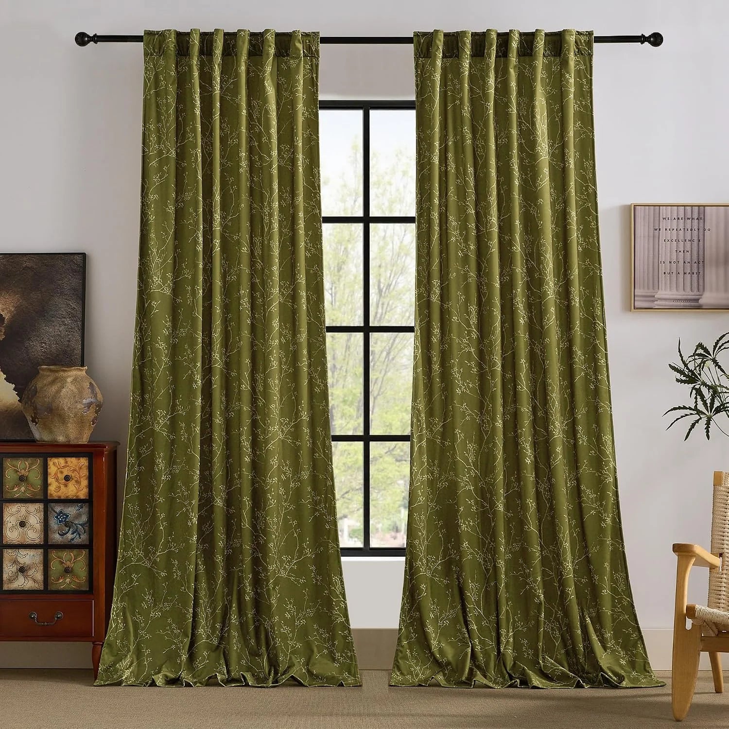 Olive green curtains with delicate botanical print hanging in a cozy living room
