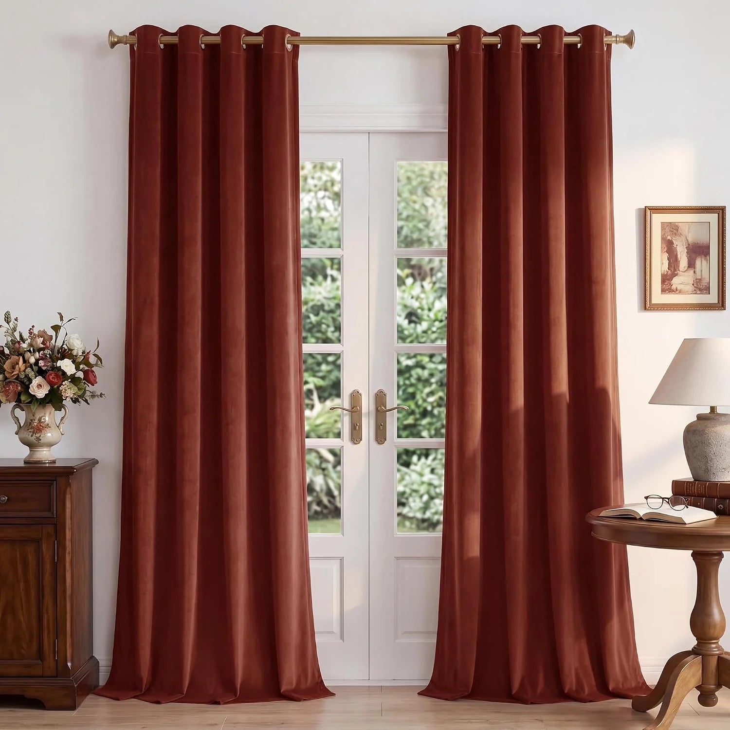 Rust velvet grommet curtains hanging over white French doors in a classic room