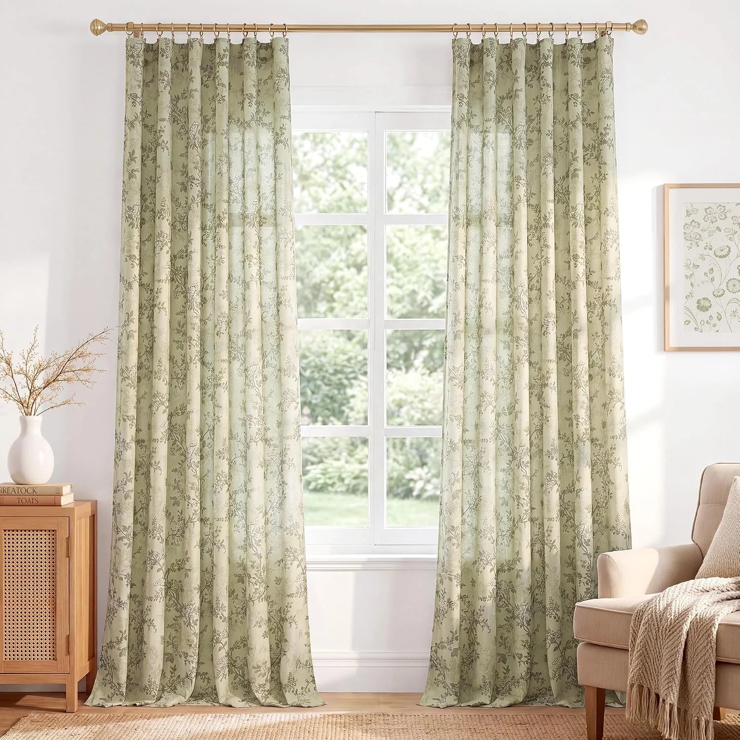 Sage green floral curtains with ring top hanging in a bright neutral living room