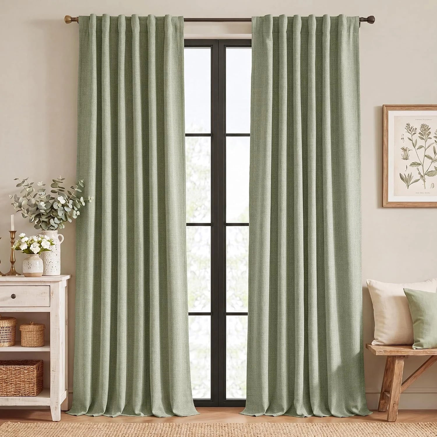 Sage green linen-look rod pocket curtains framing a black window in a cozy room