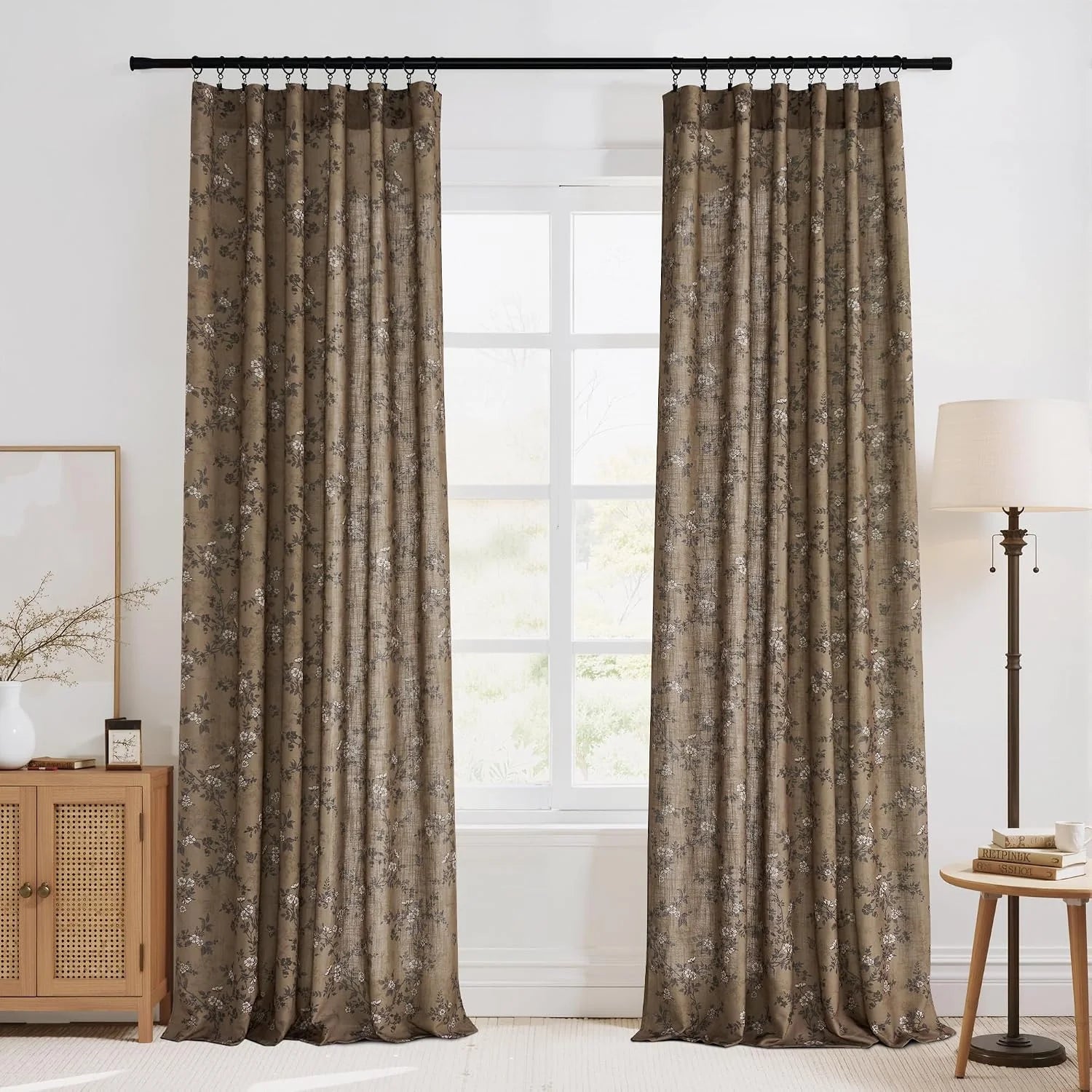 Taupe floral jacquard curtains on a black rod in a bright modern living room