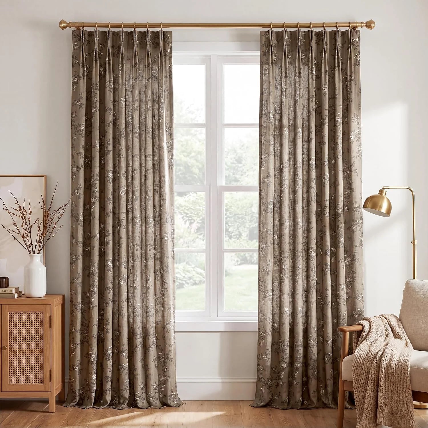 Taupe floral jacquard curtains on a brass rod in a warm neutral living room