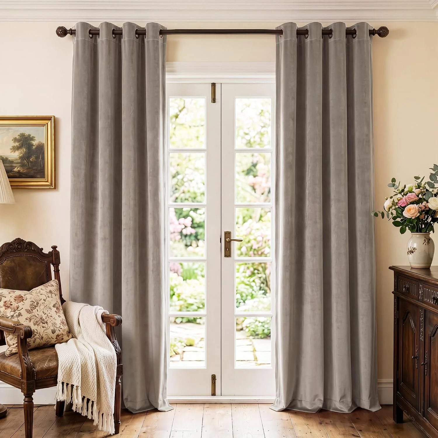 Taupe velvet grommet curtains hanging over French doors in a traditional living room