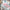 White fabric with pink floral botanical print and teal leaves in close-up
